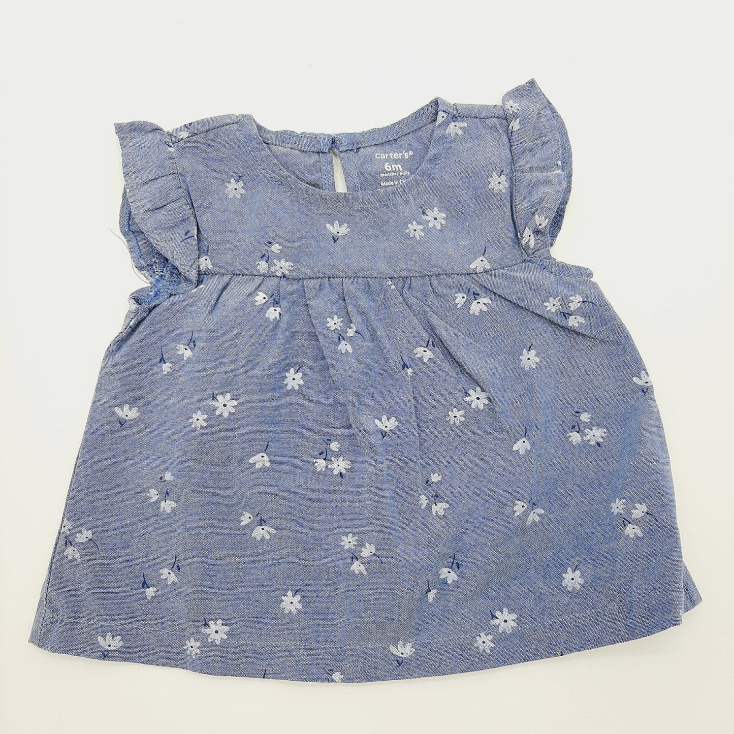 Blusa azul de flores blancas 6M marca Carter´s